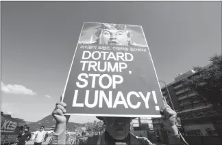  ?? AHN YOUNG-JOON / AP ?? During an Oct. 19 rally near the U.S. Embassy in Seoul, South Korea, a protester holds up a poster decrying a planned visit by U.S. President Donald Trump. Trump is scheduled to arrive in South Korea on Nov. 7 for a two-day visit and summit with South...