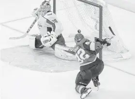  ?? Ross D. Franklin / Associated Press ?? The Golden Knights’ Tomas Nosek (92) puts the puck past the Capitals’ Braden Holtby for the go-ahead goal in the third period.