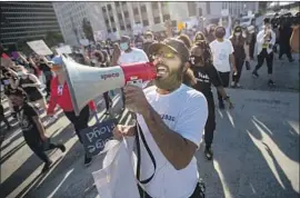  ?? Jason Armond Los Angeles Times ?? BLACK LIVES Matter supporters march in downtown Los Angeles to protest the Monday killing of George Floyd by a white Minneapoli­s police officer.