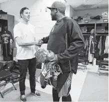  ?? Karen Warren / Houston Chronicle ?? Saturday was a day for making new friends and greeting old ones as Astros pitchers and catchers reported to spring training camp at Kissimmee, Fla. Catcher Jason Castro, left, was among the first to welcome new pitcher Jerome Williams into the fold.