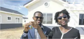  ?? (Photo: Karl Mclarty) ?? New homeowners Dewight and Dawn-marie Bailey pose with the keys to their property.