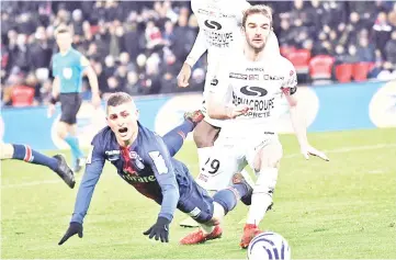  ?? - AFP photo ?? Paris Saint-Germain’s Italian midfielder Marco Verratti (left) falls next to Guingamp’s French defender Christophe Kerbrat (right) at the Parc des Princes stadium in Paris.