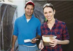  ??  ?? Ardern and Gayford painting a fence at their home in this file picture taken on Sept 23. — AP Power couple: