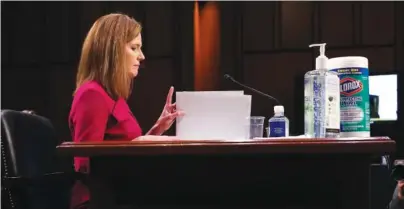  ?? LEAH MILLIS/ POOL VIA AP ?? Supreme Court nominee Amy Coney Barrett looks at her notes during her confirmati­on hearing before the Senate Judiciary Committee on Monday on Capitol Hill in Washington.