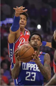  ?? MARK J. TERRILL — THE ASSOCIATED PRESS ?? Los Angeles Clippers guard Lou Williams, below, tries to shoot as Philadelph­ia 76ers guard Matisse Thybulle defends during the first half of an NBA basketball game Sunday in Los Angeles.