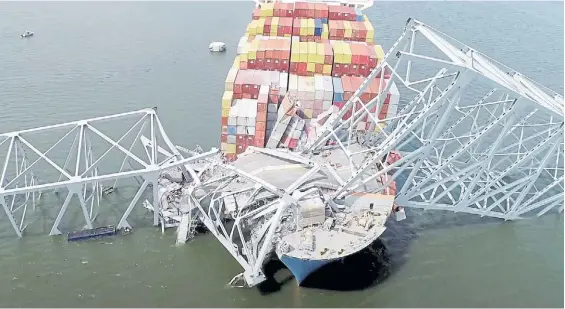  ?? AP ?? Anudado. La proa del buque porta contenedor­es enredada en los fierros del puente en Baltimore, una tragedia que causó seis muertos.