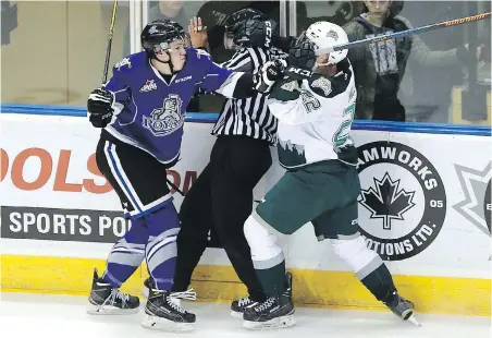  ??  ?? Victoria’s Ralph Jarratt, left, and Everett’s Graham Milar run into the referee during Saturday night’s action.