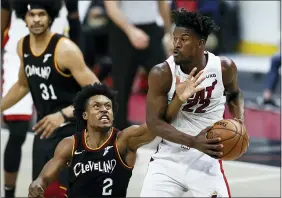  ?? RON SCHWANE — THE ASSOCIATED PRESS ?? The Heat’s Jimmy Butler grabs a rebound against the Cavaliers’ Collin Sexton during the second half May 1at Rocket Mortgage FieldHouse.