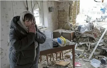  ?? ?? WRECKAGE: Halina Panasian, 69, is distraught as she stands in her destroyed house after a Russian rocket attack in Hlevakha, Kyiv region.