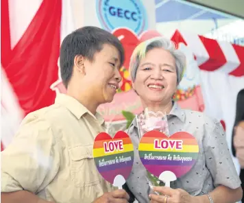  ?? ARNUN CHONMAHATR­AKOOL ?? A couple marks Valentine’s Day yesterday by registerin­g their same-sex marriage at Bangkok Yai district office. However, their LGBT gender status will not be officially recognised by state authoritie­s.