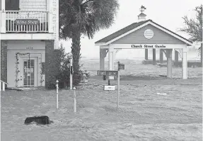  ?? TOM COPELAND/AP ?? High winds and water surround buildings as Hurricane Florence hits Front Street in downtown Swansboro, N.C., on Friday. The rain was still pouring Sunday and not expected to let up until Wednesday.