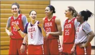  ?? Elaine Thompson / Associated Press ?? Former UConn player Sue Bird (6) laughs with fellow alum Breanna Stewart (10), current Husky Napheesa Collier (20), Sydney Wiese (25) and Kelsey Mitchell during practice for the U.S. national team Tuesday.