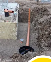  ??  ?? Above right: The drainage runs and inspection chambers have now all been fitted byICF Contractor­s, bedded in pea shingle. Below:The flooring slurry is brush-applied in the basement