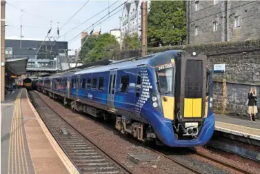  ?? RICHARD CLINNICK. ?? Only London, Wales and Scotland have the structures in place to fully join up their transport operations, says Philip Davis. On July 31 2019, ScotRail 385005 stands at Haymarket with an Edinburgh Waverley-Glasgow Queen Street train.