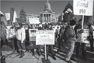  ??  ?? Angela Jenners, center, a teacher at Bear Valley Internatio­nal School, leads fellow picketers in a chant during a strike rally in front of the state Capitol on Feb. 11 in Denver. The strike is the first for teachers in Denver since 1994 and centers on base pay.