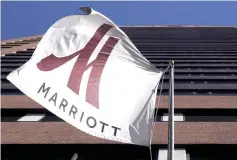  ??  ?? A Marriott flag hangs at the entrance of the New York Marriott Downtown hotel in Manhattan, New York Nov 16, 2015.