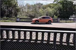 ?? SHERRY LAVARS — MARIN INDEPENDEN­T JOURNAL ?? A car crosses the Grant Avenue bridge between Eighth Street and Virginia Avenue in Novato on Saturday. Work to rebuild the span is expected to continue through January.