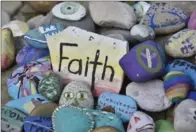  ?? PHOTOGRAPH­Y BY JOHN RENNISON, THE HAMILTON SPECTATOR ?? Art therapy stones that clients created during their stay are part of the rock garden at the Barrett Centre on Emerald Street South.