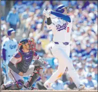  ?? Ashley Landis The Associated Press ?? Shohei Ohtani follows through on the second of his two homers in front of Braves catcher Travis d’arnaud in the Dodgers’ 5-1 victory.