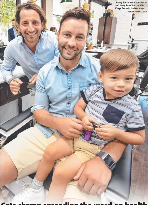  ?? Picture: TONY GOUGH ?? Jimmy Bartel with son Aston and Joey Scandizzo at the Kings Domain barber shop.