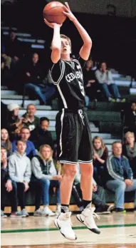  ?? CALVIN MATTHEIS / FOR THE MILWAUKEE JOURNAL SENTINEL ?? Cedarburg’s Jordan Johnson attempts a three-pointer against Wisconsin Lutheran Friday night. He finished with 27 points.