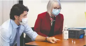 ?? ADRIAN WYLD / POOL VIA REUTERS ?? Prime Minister Justin Trudeau, seen at The Ottawa Hospital's Civic campus with Health Minister Patty Hajdu, has staked his political future to the delivery of COVID vaccines.