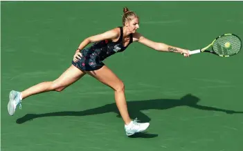  ?? AFP ?? Czech Republic’s Kristyna Pliskova hits a forehand against Simona Halep of Romania in their BNP Paribas Open first round in Indian Wells, California, on Friday. Halep won 6- 4, 6- 4. —