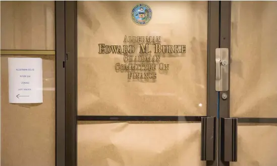  ?? ASHLEE REZIN/SUN-TIMES ?? Brown paper put up by federal agents covers the windows of Ald. Edward Burke’s office on Nov. 29 at City Hall.