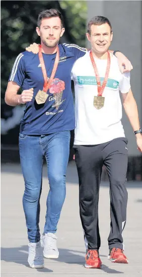  ?? Adam Davy ?? > Swansea Harriers’ Matthew Rees, left, with Chorlton Runners’ David Wyeth at The Tower Bridge Hotel, yesterday. Wyeth was struggling to make it to the London Marathon’s finishing line on The Mall when Rees came to his aid on Sunday, below, in a...