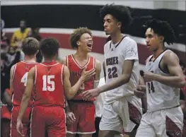  ?? Jason Armond Los Angeles Times ?? HARVARD-WESTLAKE guard Trent Perry, middle, shouts in celebratio­n during the Wolverines’ victory in the Open Division regional final. Perry scored 25 points.