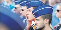  ?? PHOTO: REUTERS ?? Emotions high . . . A policewoma­n reacts during a minute of silence in Liege, Belgium yesterday.