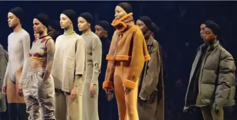  ?? BRUCE BARTON/THE ASSOCIATED PRESS ?? Models present Kanye West’s collection at Madison Square Garden in New York. West populated the production with men and women of colour.