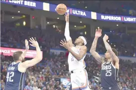  ?? AP PHOTO ?? Oklahoma City Thunder guard Shai Gilgeous-Alexander (2) shoots from between Dallas Mavericks forward Maxi Kleber (42) and P.J. Washington (25) during the second half of an NBA basketball game Thursday, March 14, 2024, in Oklahoma City.