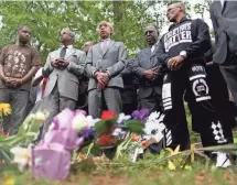  ?? JOE RAEDLE, GETTY IMAGES ?? Al Sharpton, center, joins a group prayer last April at the site where Walter Scott was killed by a police officer April 4, 2015, in North Charleston, S.C.