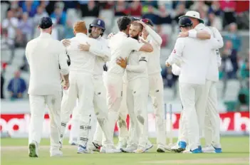  ?? — Reuters ?? England’s Moeen Ali celebrates taking the wicket of South Africa’s Duanne Olivier and winning the match with team-mates.