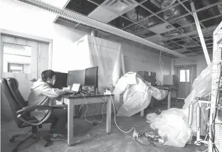  ?? Steve Gonzales/Houston Chronicle via AP ?? Zucheng Wang continues his research in a Hurricane Harvey damaged lab on Dec. 7 at the University of Texas at Austin’s Marine Science Institute in Port Aransas, Texas.