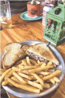  ?? STAFF PHOTO BY KATE BRENNAN ?? The Basecamp Melt is a juicy beef patty with pepper jack cheese, sauce and sauteed onions on sourdough bread.