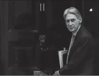  ?? AP/KIRSTY WIGGLESWOR­TH ?? Britain’s Treasury chief, Philip Hammond, leaves 11 Downing Street to attend the weekly session of Prime Ministers Questions in Parliament in London in March.