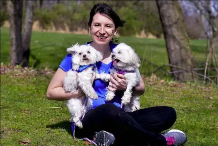  ?? Robin Rombach/Post-Gazette photos ?? Nicole Orlando of Plum with her two Maltese, Jupiter and Penelope. She organized a fundraisin­g walk Sunday in Boyce Park to benefit the Northcentr­al Maltese Rescue Inc., which helps puppy mill dogs. Jupiter is from a puppy mill in Montana.