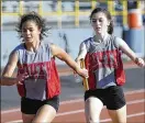  ??  ?? Twin Valley South sophomore Sidney Mowell (right) hands off to junior teammate Mylan Crews in the 4x200 relay during Tuesday’s meet.