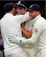  ??  ?? At last: Root and Bairstow embrace Cook after he puts an earlier drop behind him to catch Shai Hope