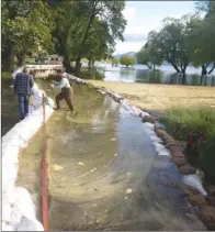  ?? The Okanagan Weekend ?? Flood waters are threatenin­g the Red Wing subdivisio­n in Penticton again. A structure built last weekend to hold back the water must be raised immediatel­y or a large section of the community will flood, said city engineer Mitch Moroziuk. The city took...