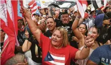  ?? Joe Raedle / Getty Images ?? People celebrate as they anticipate that Ricardo Rosselló, the governor of Puerto Rico, will leave the Governor’s Mansion on Friday in San Juan. Rosselló agreed to step down.