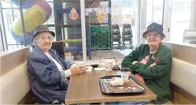  ?? Staff photo by Neil Abeles ?? ■ In their rain hats are Mary Draper Whitlow, left, and Sue Draper Easley at their weekly Thursday morning coffee talk at the local Burger King in Atlanta, Texas. For them, the recent Veterans Day had been especially memorable.