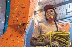  ??  ?? Dillon Smith, a customer service representa­tive at Stone Age Climbing Gym, poses for a portrait with rope used to belay climbers.