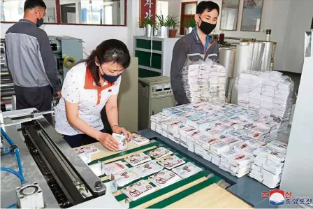  ??  ?? Tit-for-tat: This undated picture released by KCna shows north Koreans preparing anti-Seoul leaflets at an undisclose­d location in north Korea. — aFP