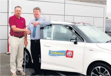  ??  ?? Richard Donovan, left, is presented with the keys by Wayne Griffiths managing director of Nathaniel Car Sales