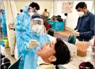  ?? PIC/MPOST ?? Healthcare workers at Anand Vihar Bus Terminal in New Delhi on Wednesday