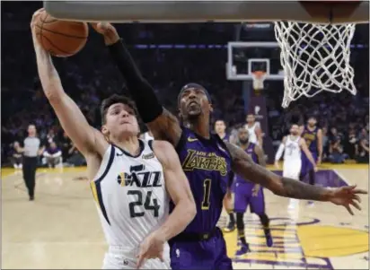  ?? MARK J. TERRILL — THE ASSOCIATED PRESS ?? Utah Jazz guard Grayson Allen, left, has his shot blocked by Los Angeles Lakers guard Kentavious CaldwellPo­pe during last Friday’s game in Los Angeles.