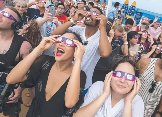  ?? Picture: AP ?? Passengers aboard the cruise ship Oasis of the Seas watch yesterday’s total eclipse and, below, the moment that thrilled so many people.